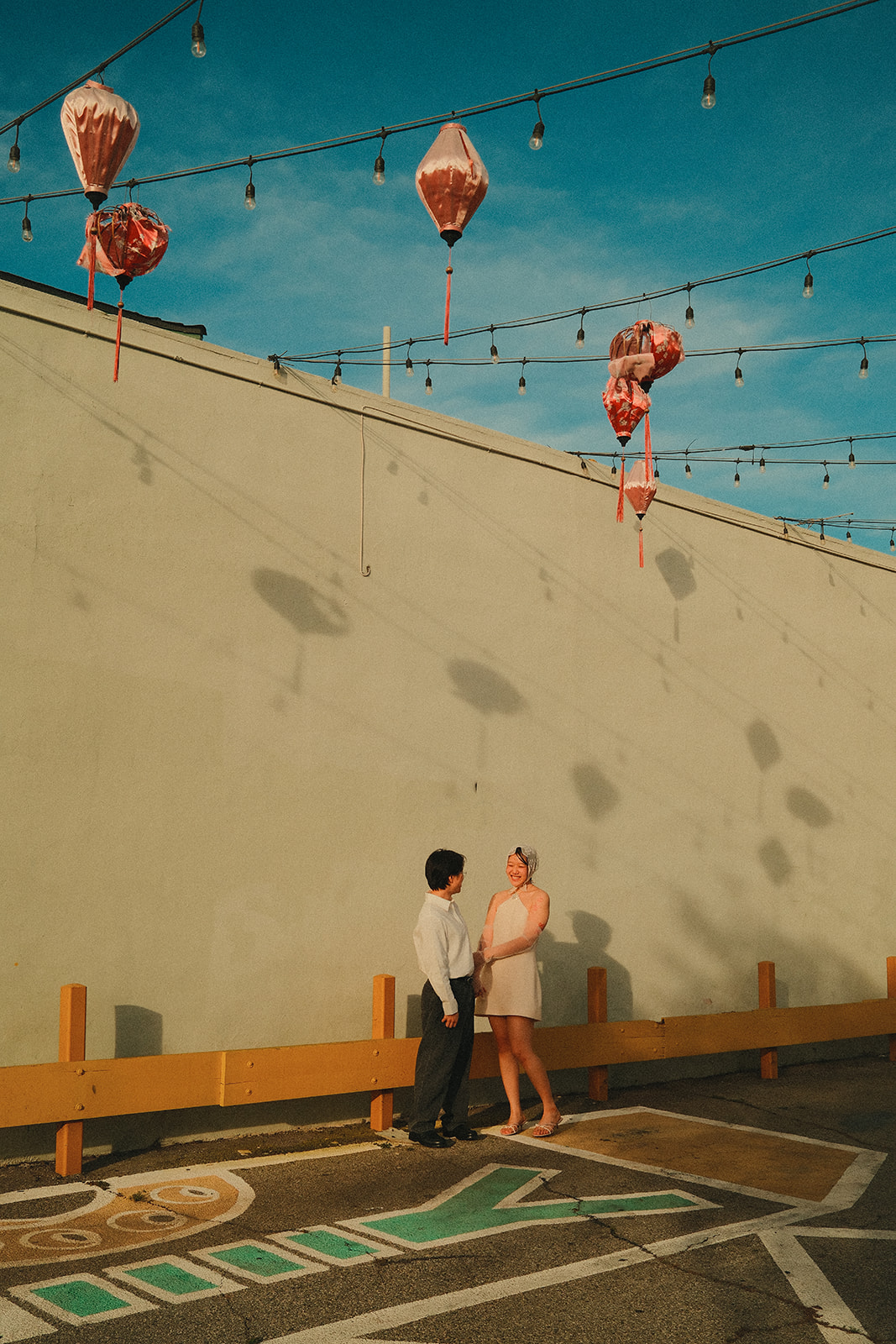 Together under string lights and pink lanterns