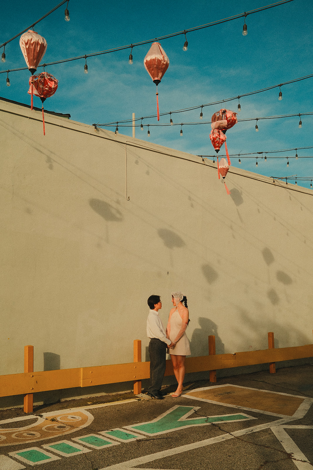 Facing each other under the lanterns