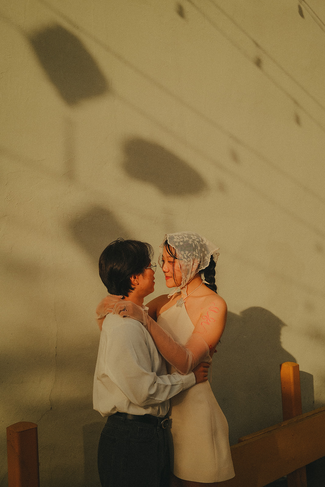Golden hour portrait against a warm wall