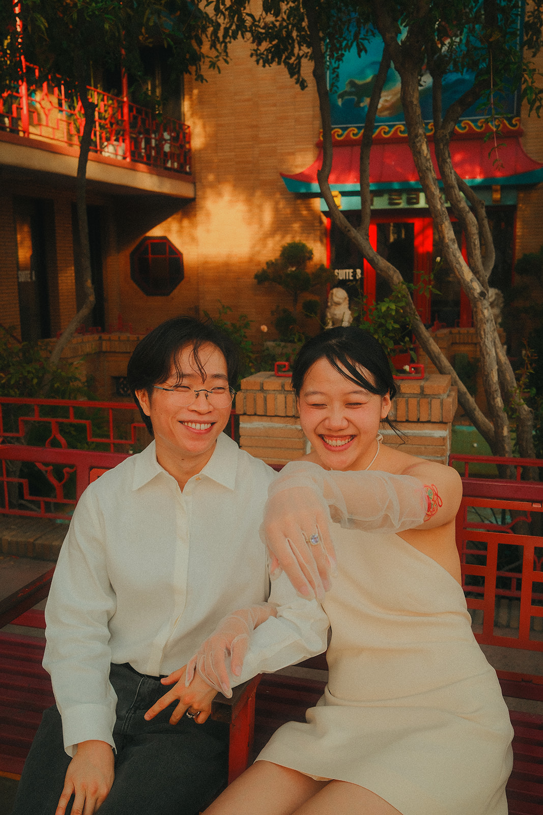 Laughing together on a red bench